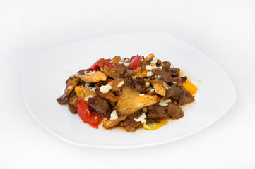 Beef stew with mushrooms and sweet pepper on a large white plate on a white background