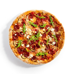 Pepperoni pizza slices with arugula on plate