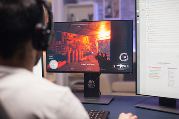 Guy with headphones playing shooter game © DC Studio