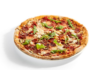 Pepperoni pizza slices with arugula on plate