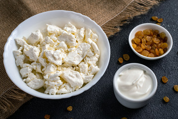 Cottage cheese with sour cream and raisins. Farm products, close-up.
