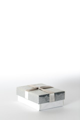 Small silver gift box with a silver bow