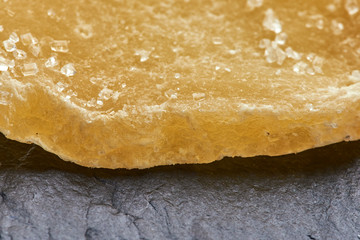 dried mango fruit lies on a black rough surface. macro photo.