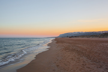 lonely mediterranean beach at sunset