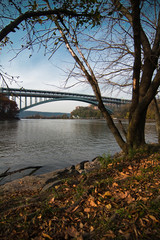 steel bridge crossing a lagoon in an autumnal park