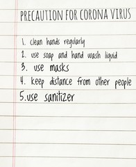 precautions list for corona virus infection written in white line notebook paper , personal care and safety measures for covid 19 