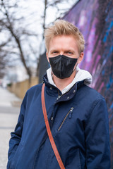 Fototapeta na wymiar European man travel wearing black face protection agains coronavirus