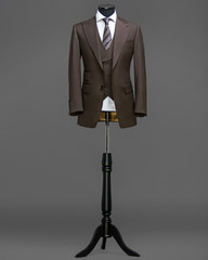 Atelier to repair clothes, Stylish look, Fashion look, Men look, Wedding style, Fashion concept, Brand clothing, Classic costume,Suit on grey background. Store display. Classic style.