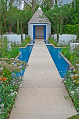A modern showgarden with water feature, alcoves for flowers.