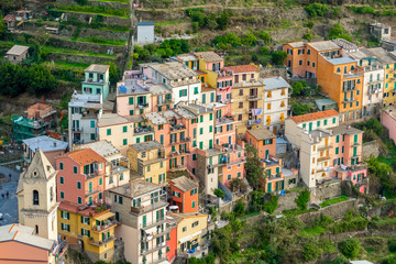 Fototapeta na wymiar Nice aerial landscape view of the little town of Manarola in the Cinque Terre in Liguria Italy. It is a small colorful village perched on the rocks with a fantastic view of the Mediterranean sea
