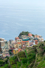 Fototapeta na wymiar Aerial detail landscape view of the little town of Manarola in the Cinque Terre in Liguria Italy. It is a small colorful village perched on the rocks with a fantastic view of the Mediterranean sea