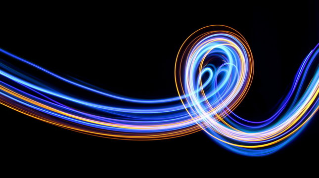Light painting photography, long exposure photo of blue and gold loops and swirls of vibrant color, fairy lights against a black background