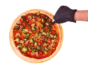 Hand cutting pizza with veggie vegetables, on bamboo bottom, isolate on white, top view