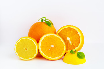 Juicy orange on a white background.Orange fruit with orange slices and leaves isolated on a white background.Vitamin C.Orange close-up.Vegetarian, vegan food.Fresh citrus fruits.Lemons with orange.