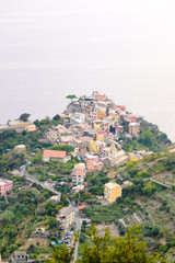 Fototapeta premium Nice aerial landscape view of the little town of Corniglia in the Cinque Terre in Liguria Italy at sunset. A small colorful village perched on the rocks with a fantastic view of the Mediterranean sea