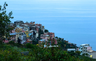 Fototapeta na wymiar Nice aerial landscape view of the little town of Corniglia in the Cinque Terre in Liguria Italy at dusk. A small colorful village perched on the rocks with a fantastic view of the Mediterranean sea