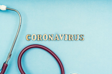 Coronavirus, covid-19. The inscription coronavirus on a blue background. Self-isolation and quarantine, personal protective equipment, phonendoscope and stethoscope.