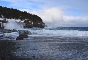 Winter beach seascape, with good waves and great clouds, Middle Cove NL Canada