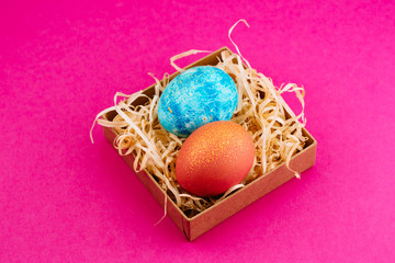 Easter egg is colored blue with gold and orange with gold.