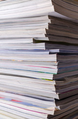 Closeup background of a pile of magazines.