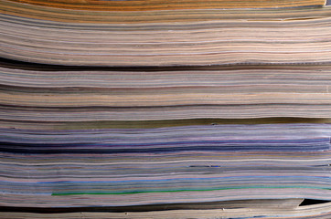 Closeup background of a pile of magazines.