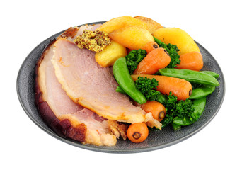 Roast gammon and vegetable meal isolated on a white background
