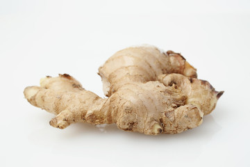 Close up of Fresh Ginger root or rhizome isolated on white