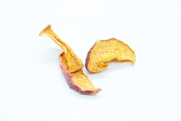 pieces of dry apples placed on a white background