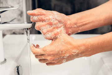 Fototapeta premium Coronavirus. Proper washing and handling of hands. Liquid antibacterial soap. Self-isolation and hygiene.