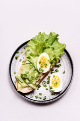 Open sandwich with cream cheese, cucumber, lettuce and egg. Morning and Breakfast. Healthy nutrition. Selective focus