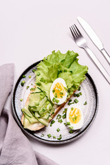 Open sandwich with cream cheese, cucumber, lettuce and egg. Morning and Breakfast. Healthy nutrition. Selective focus
