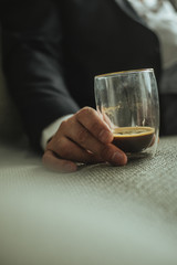 Glass of coffee in hand