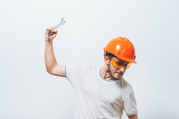 Portrait of young handyman holding a wrench