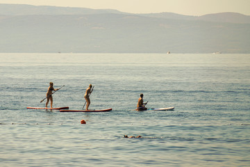 Naklejka premium SUP-surfing is a great board balance simulator