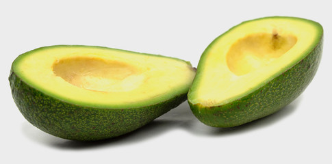 Avocado cut into two parts isolate