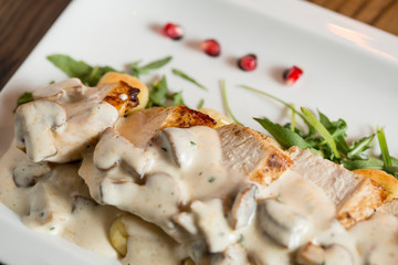 Chicken meat on grated gnocchi in cream sauce of mushrooms and smoked cheese