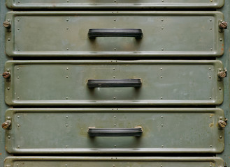 Old green metal closet with pullout drawers