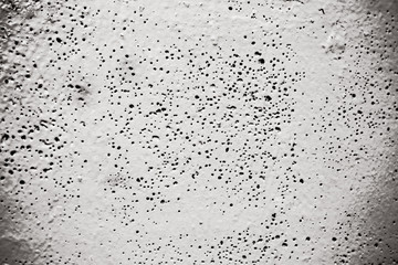 gray cement background with pores and holes