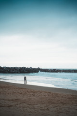 Fototapeta na wymiar Surfer standing on the shore before entering the water