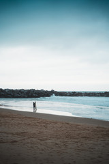 Fototapeta na wymiar Surfer standing on the shore before entering the water