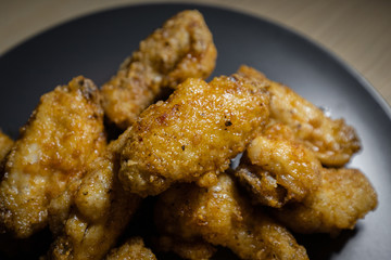 Close-up view of fried chicken wing piece.
