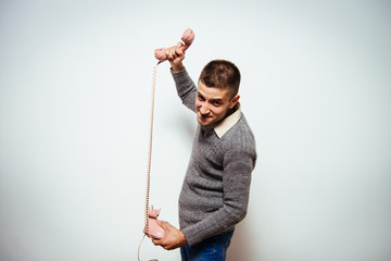 Close up image of a man screaming on the telephone during the conversation.