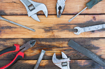 Set of old tools and instruments on wood texture background. Assorted building tools. Screwdriver, wrench, pliers. Space for text.