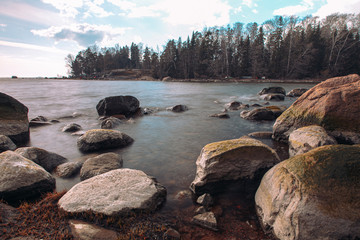 Scandinavian seascape. Waves and rocky coast. Finland. March 2020. Stylized photographs.