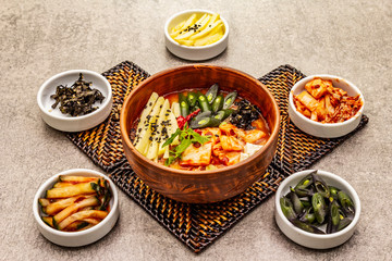 Traditional Korean spicy soup with kimchi, tofu, vegetables. Hot dish for healthy meal