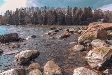 Scandinavian seascape. Waves and rocky coast. Finland. March 2020. Stylized photographs.