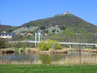 beautiful lake overlooking a castle on top of a hill