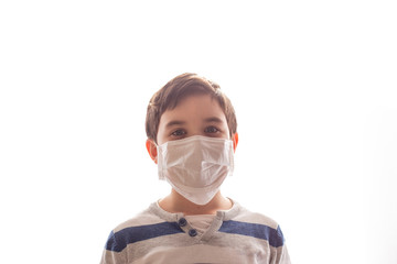 Portrait of a boy on white background in a white medical mask