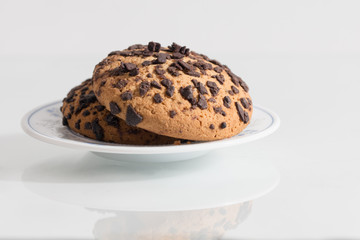 Crispy biscuits with chocolate flakes on white background