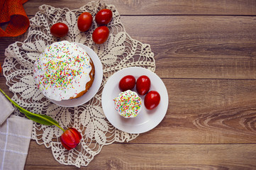 Easter cake and painted eggs on a table. Traditional orthodox christian easter food. Top view.
